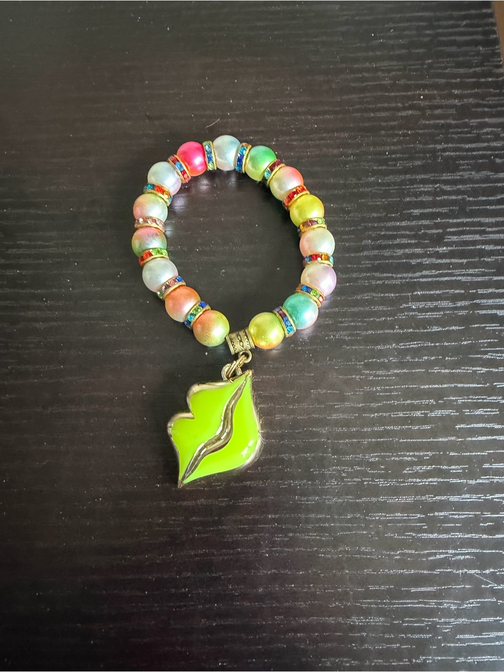 Colorful  beaded stretch bracelet featuring a vibrant lime-green lips charm